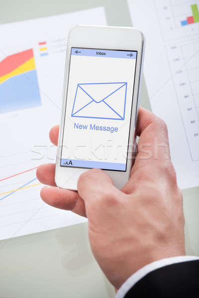 Nouvelle courriel un message icône téléphone portable main Photo stock © AndreyPopov