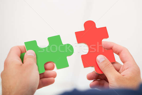 Man Joining Puzzle Pieces Stock photo © AndreyPopov