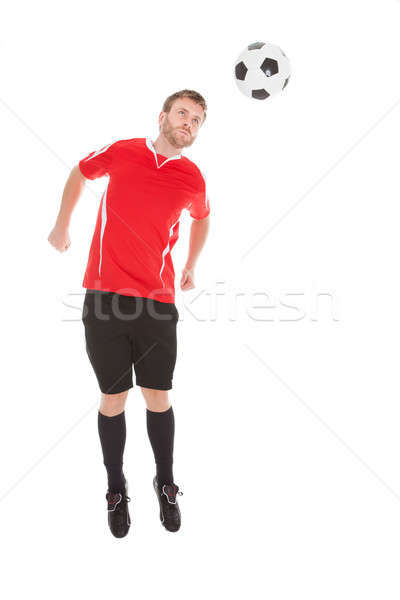 Stock photo: Soccer Player Jumping Over White Background