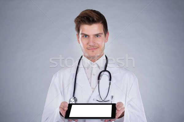 Stock photo: Portrait Of Confident Doctor Holding Digital Tablet