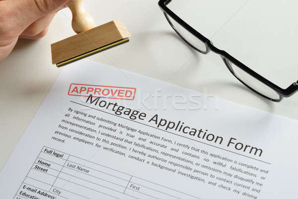 Person Hand With Stamp And Approved Mark On Mortgage Application Stock photo © AndreyPopov