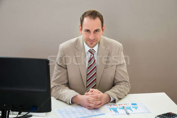 Businessman With Gantt Chart Sitting At Desk Stock photo © AndreyPopov