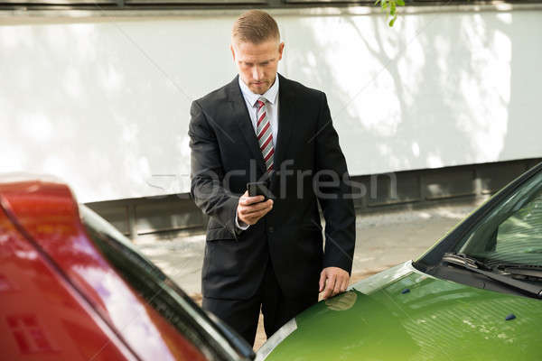 Man Photographing His Vehicle After Traffic Collision Stock photo © AndreyPopov