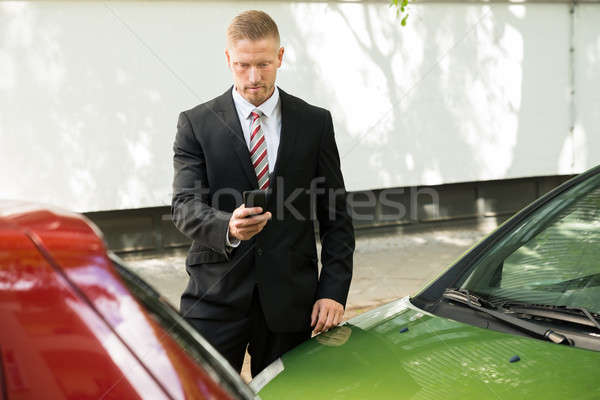 Man Photographing His Vehicle After Traffic Collision Stock photo © AndreyPopov