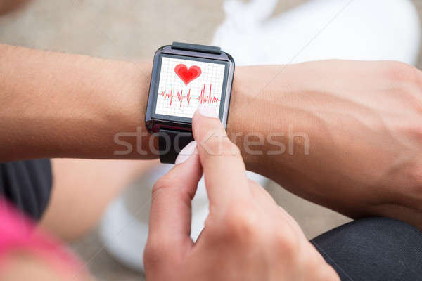 Human Hand Wearing Smart Watch Showing Heartbeat Rate Stock photo © AndreyPopov