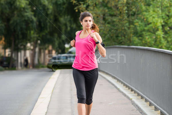 Athlete Woman Running On Sidewalk Stock photo © AndreyPopov