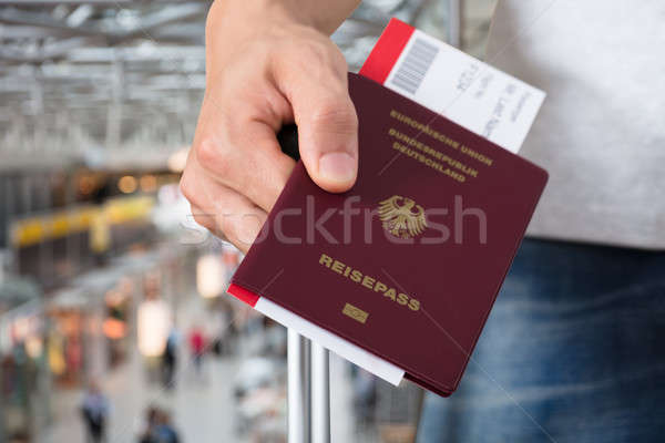 Person With Luggage Holding Passport And Boarding Pass Tickets Stock photo © AndreyPopov