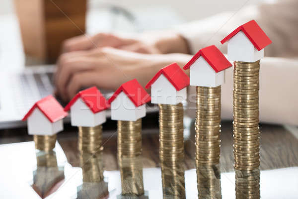 Miniature Houses Over The Stack Of Coins On Wooden Table Stock photo © AndreyPopov