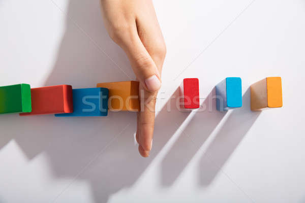 Businessperson Hand Stopping Colorful Blocks From Falling Stock photo © AndreyPopov