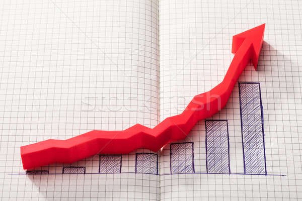 Red Arrow Over Increasing Graph On Notebook Stock photo © AndreyPopov