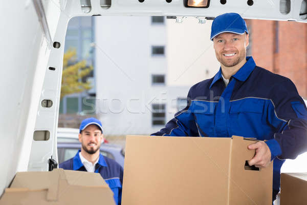 Mover Unloading Cardboard Box From Truck Stock photo © AndreyPopov