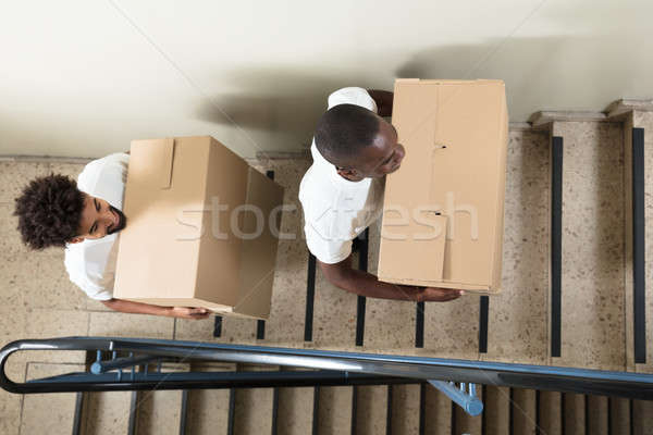 Portrait Of Two Movers Holding Cardboard Boxes Stock photo © AndreyPopov