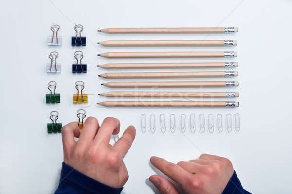 Human Hand Arranging Office Supplies Stock photo © AndreyPopov