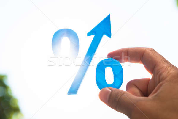 Man holding percentage sign with arrow Stock photo © AndreyPopov