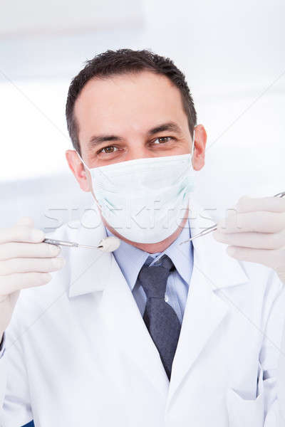 Portrait Of Male Dentist Holding Angled Mirror And Carver Stock photo © AndreyPopov