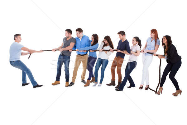 Group of people having a tug of war Stock photo © AndreyPopov