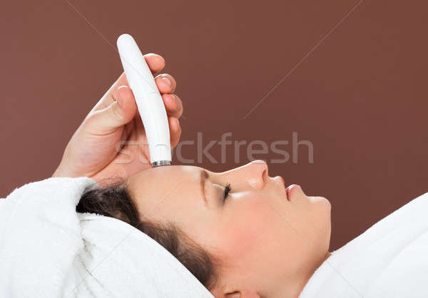 Woman Receiving Microdermabrasion Therapy On Forehead At Spa Stock photo © AndreyPopov