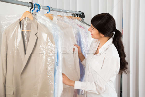 Woman Looking At Clothes In Shop Stock photo © AndreyPopov