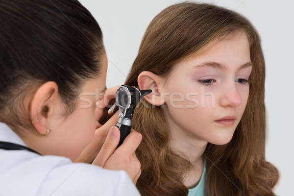 Doctor Examining Patient Ear With Otoscope Stock photo © AndreyPopov