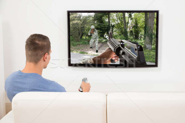 Man Playing Computer Game On Television Stock photo © AndreyPopov