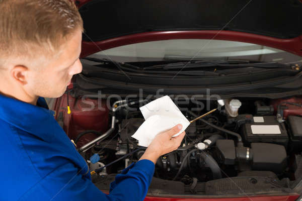 Stock photo: Mechanic Checking Oil Level In Car Engine