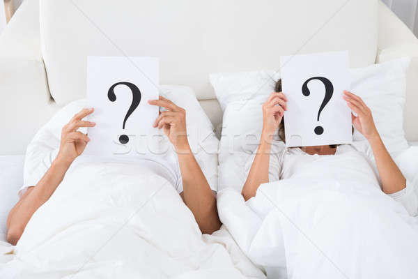 Couple Holding Question Mark Over Faces Stock photo © AndreyPopov