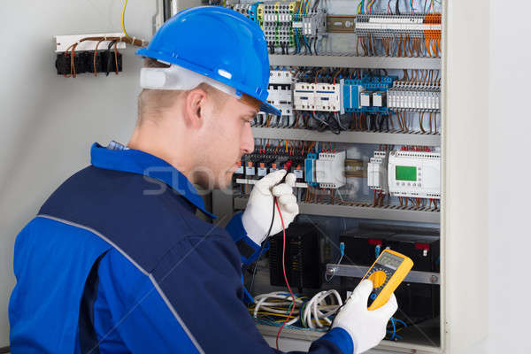 Male Technician Examining Fusebox Stock photo © AndreyPopov