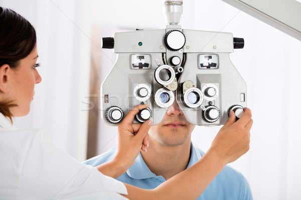 Female Optometrist Adjusting Phoropter For Patient Stock photo © AndreyPopov