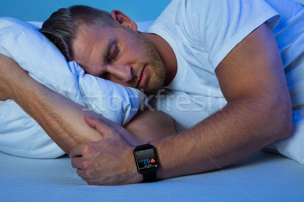 Férfi alszik okos óra kéz mutat Stock fotó © AndreyPopov