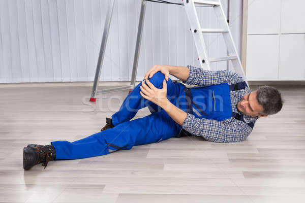 An Injured Man Holding His Leg Stock photo © AndreyPopov