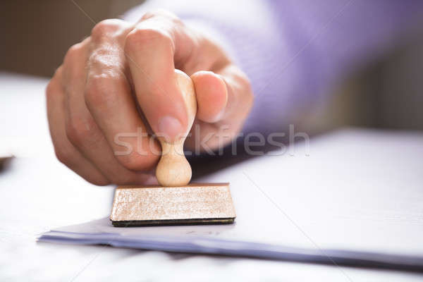 Close-up Of A Person Stamping On Document Stock photo © AndreyPopov