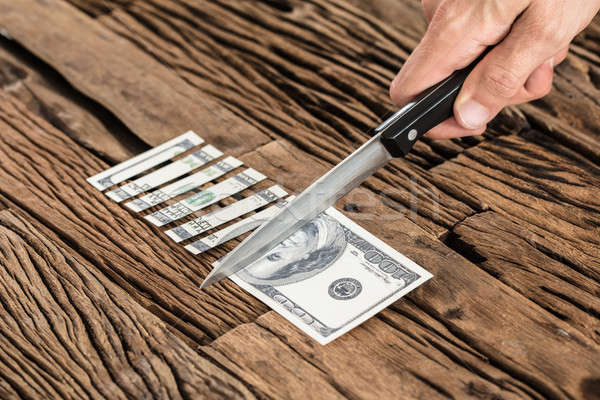 Hand Cutting The 100 Dollar Bill With Knife Stock photo © AndreyPopov