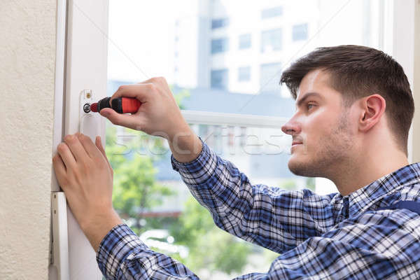 Handyman Fixing Window With Screwdriver Stock Photo C Andreypopov 8473868 Stockfresh