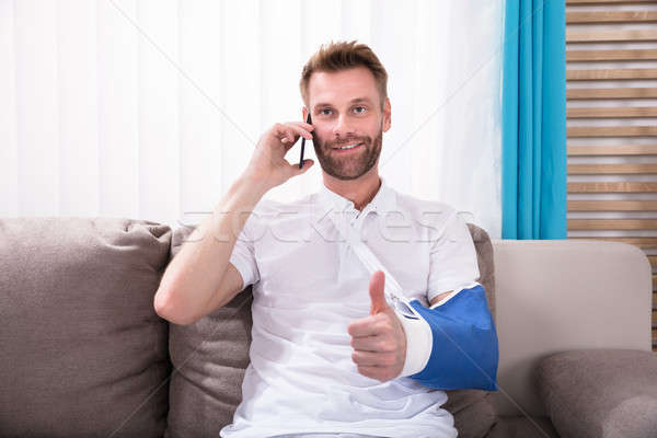 Man With Fractured Hand Gesturing Thumbs Up Stock photo © AndreyPopov