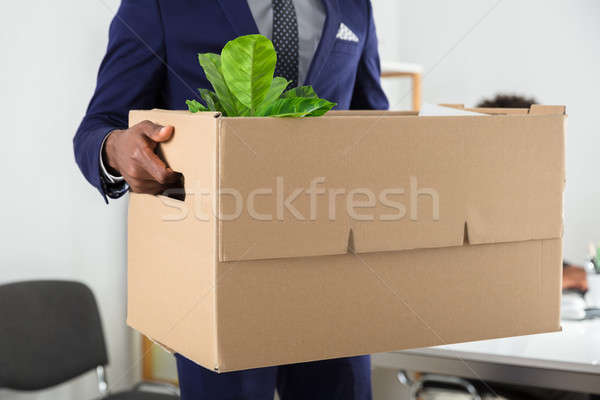 Businessperson Holding Belongings In Cardboard Box Stock photo © AndreyPopov