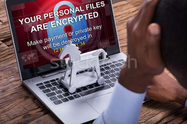 Worried Businessman Encrypted Text On The Laptop Stock photo © AndreyPopov