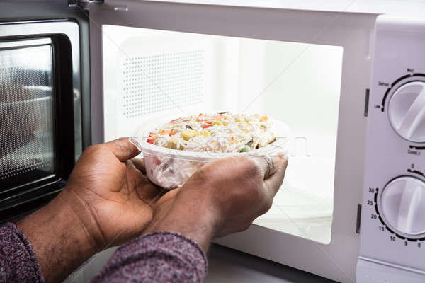 Man's Hand Heating Food In Microwave Oven Stock photo © AndreyPopov