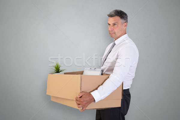 Sad Businessman Carrying Belongings In Cardboard Box Stock photo © AndreyPopov
