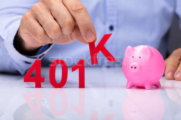 Person Picking K Alphabet From 401k Pension Plan Stock photo © AndreyPopov