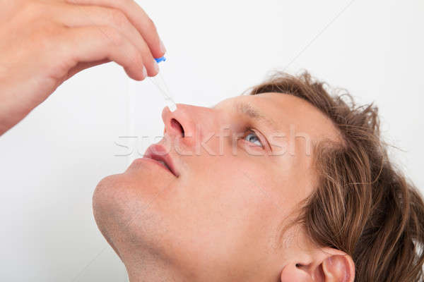 Young Man Using Nasal Spray Stock photo © AndreyPopov