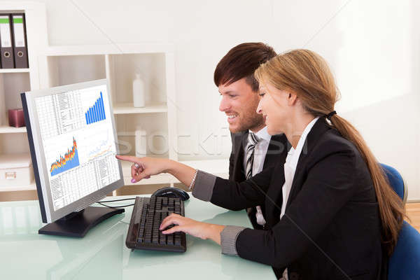 Business people looking at sales charts Stock photo © AndreyPopov