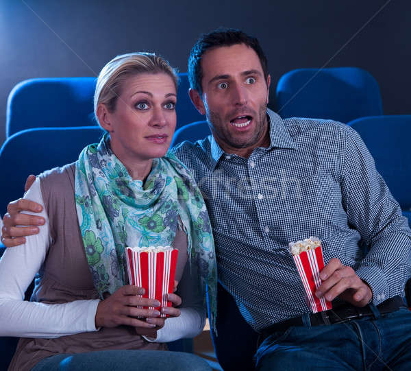 Stock photo: Couple watching a movie reacting in horror