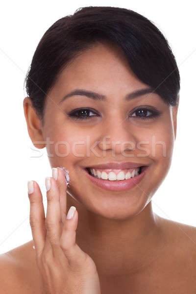 Young Woman Applying Cream On Her Face Stock photo © AndreyPopov