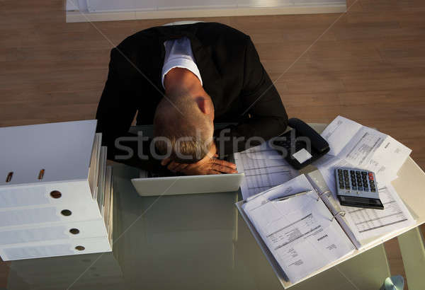 Exhausted businessman sleeping an a stack of files Stock photo © AndreyPopov