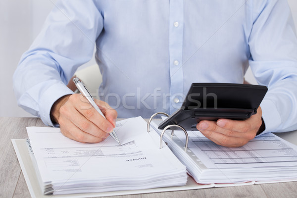 Businessman Calculating Financial Expenses Stock photo © AndreyPopov