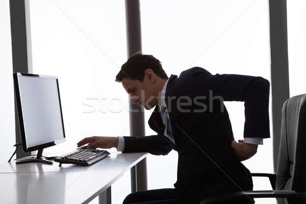 Biznesmen cierpienie ból w krzyżu biuro widok z boku młodych Zdjęcia stock © AndreyPopov