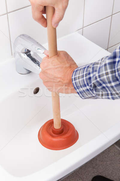 Plumber Pressing Plunger In Sink Stock photo © AndreyPopov