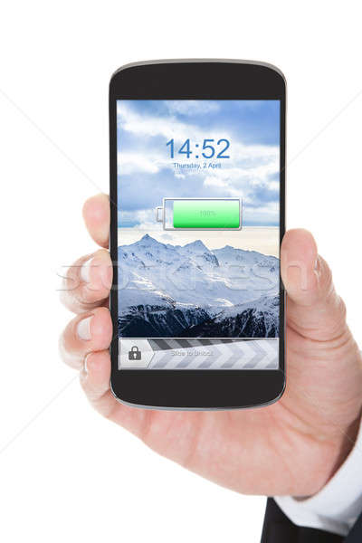 Hand With Mobile Phone Showing Charged Battery Stock photo © AndreyPopov