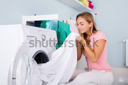 Stock photo: Woman Using Plunger In Sink