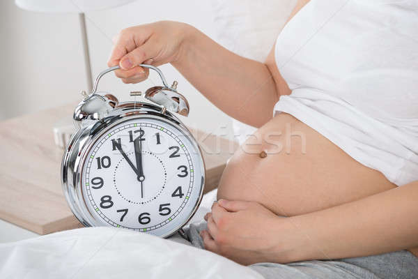 Zwangere vrouw wekker klok home Stockfoto © AndreyPopov